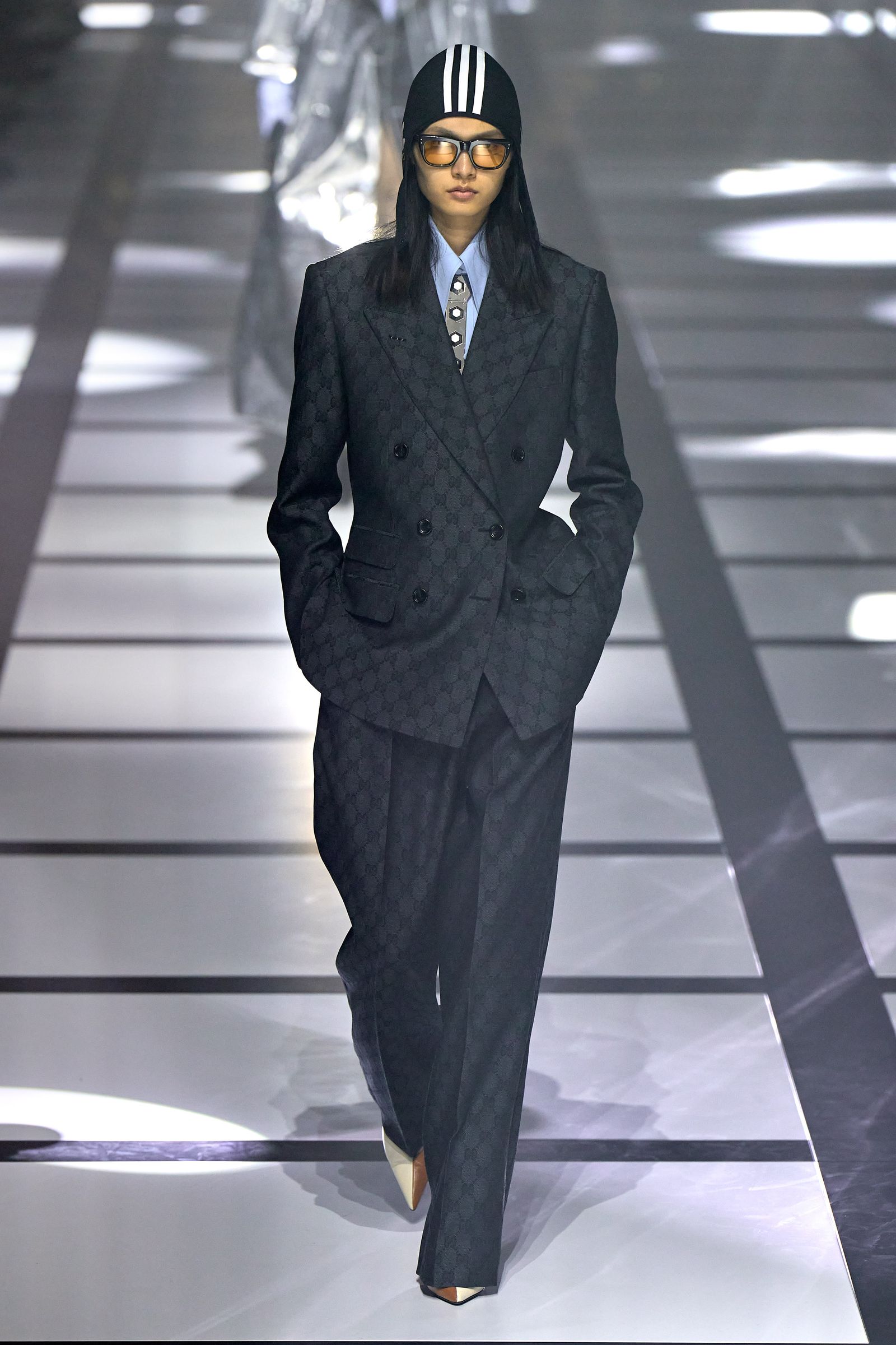 Image may contain Clothing Suit Overcoat Apparel Coat Human and Person