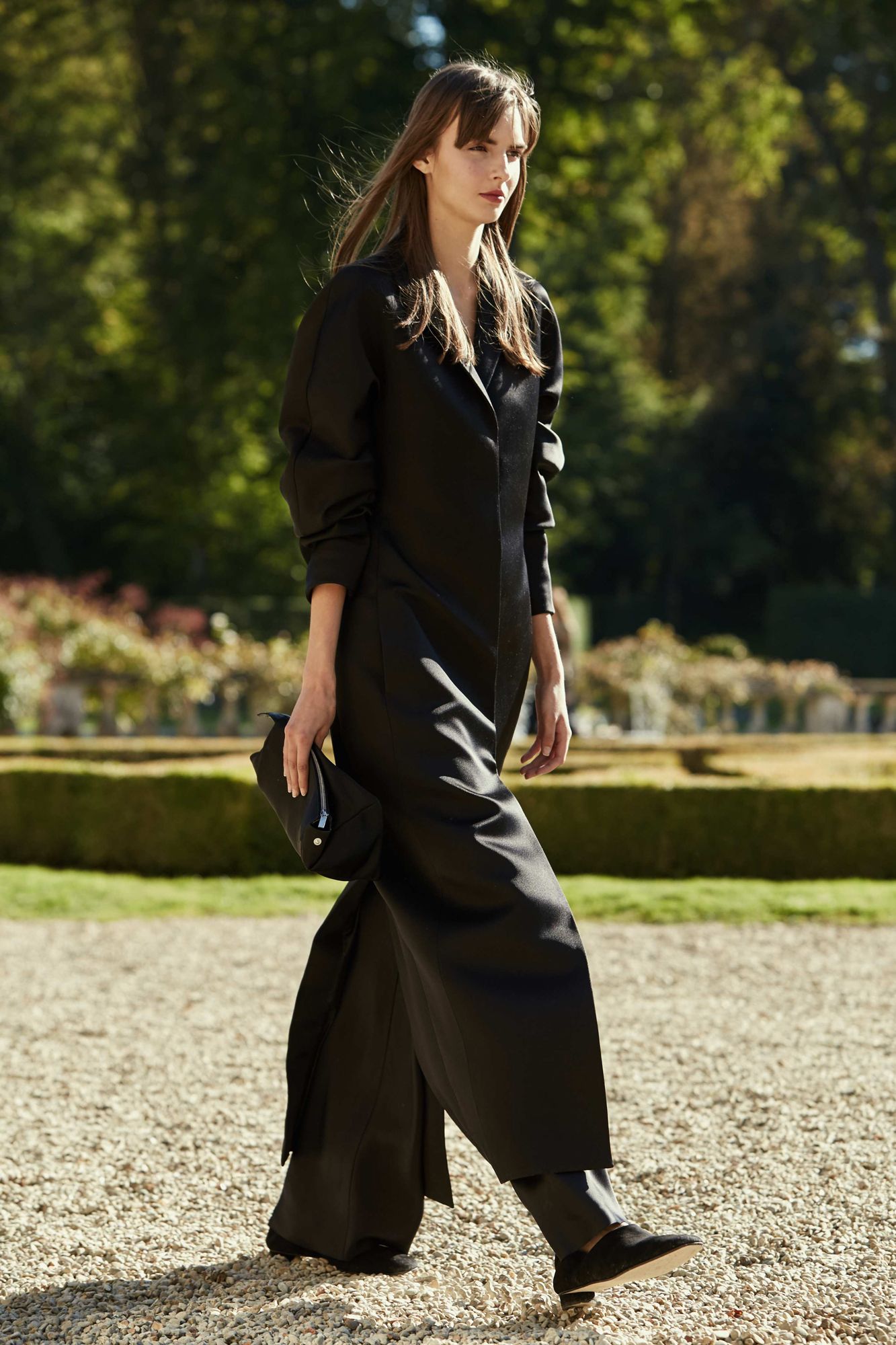 This image may contain Clothing Apparel Evening Dress Robe Fashion Gown Human Person Sleeve Footwear and Shoe