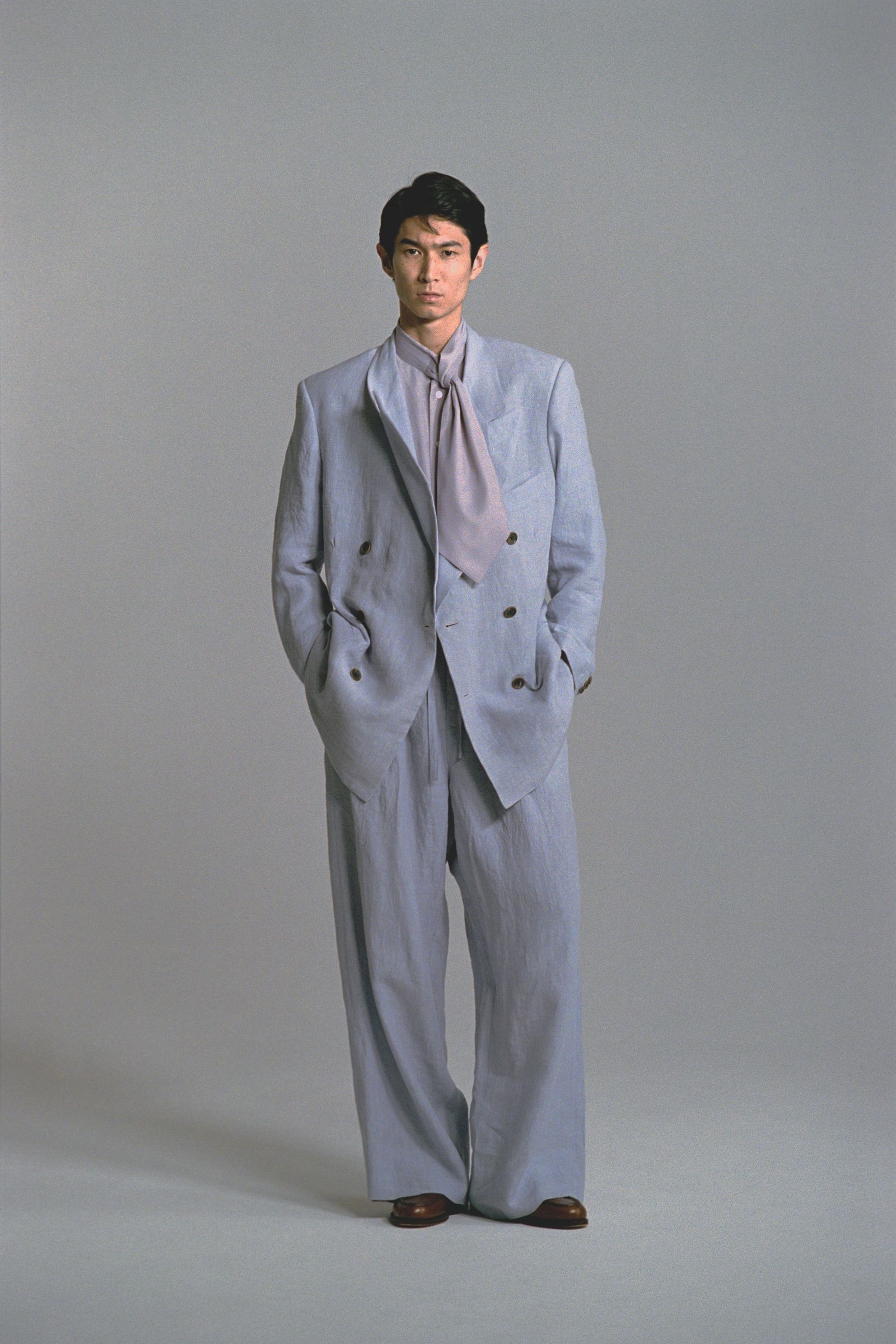 Image may contain Clothing Formal Wear Suit Coat Blazer Jacket Tuxedo Adult Person Home Decor Linen and Footwear