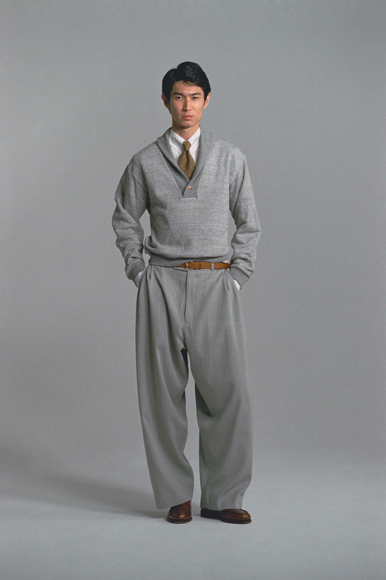 Image may contain Formal Wear Clothing Suit Adult Person Accessories Tie Pants Belt Home Decor Linen and Fashion