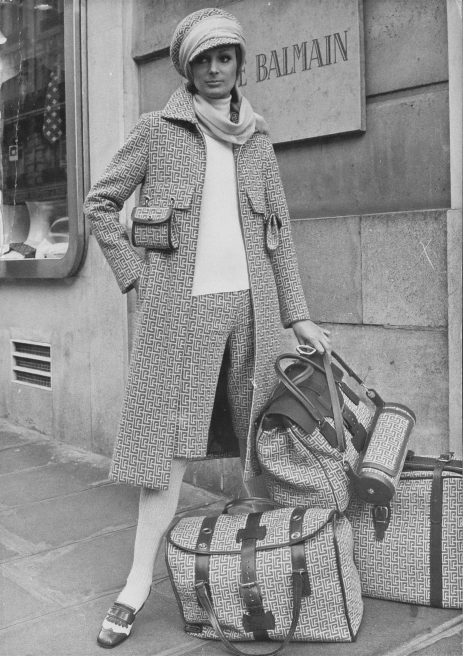 Vintage photograph of the iconic “Le Mans” full PB monogram travel ensemble Balmain Haute Couture SpringSummer 1971. ©...