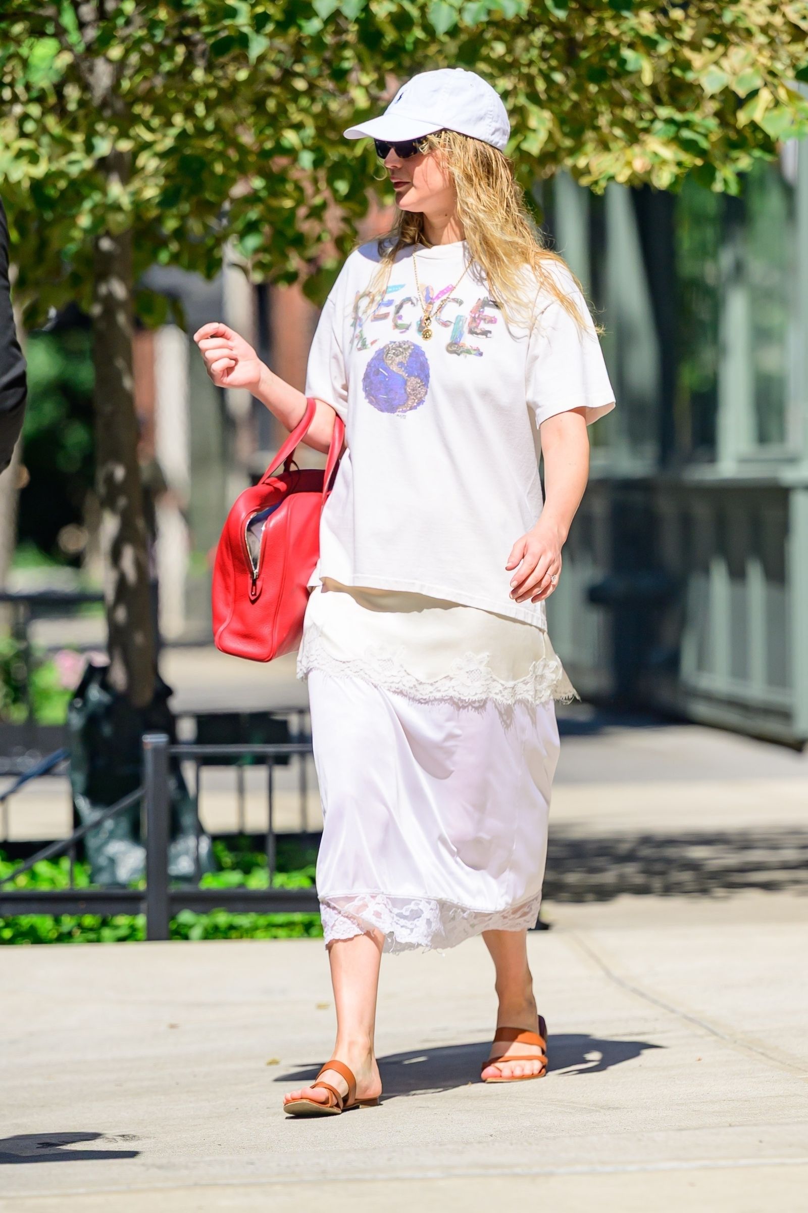 Image may contain Accessories Bag Handbag Adult Person Clothing Shorts Hat Glasses Footwear Sandal and Jewelry