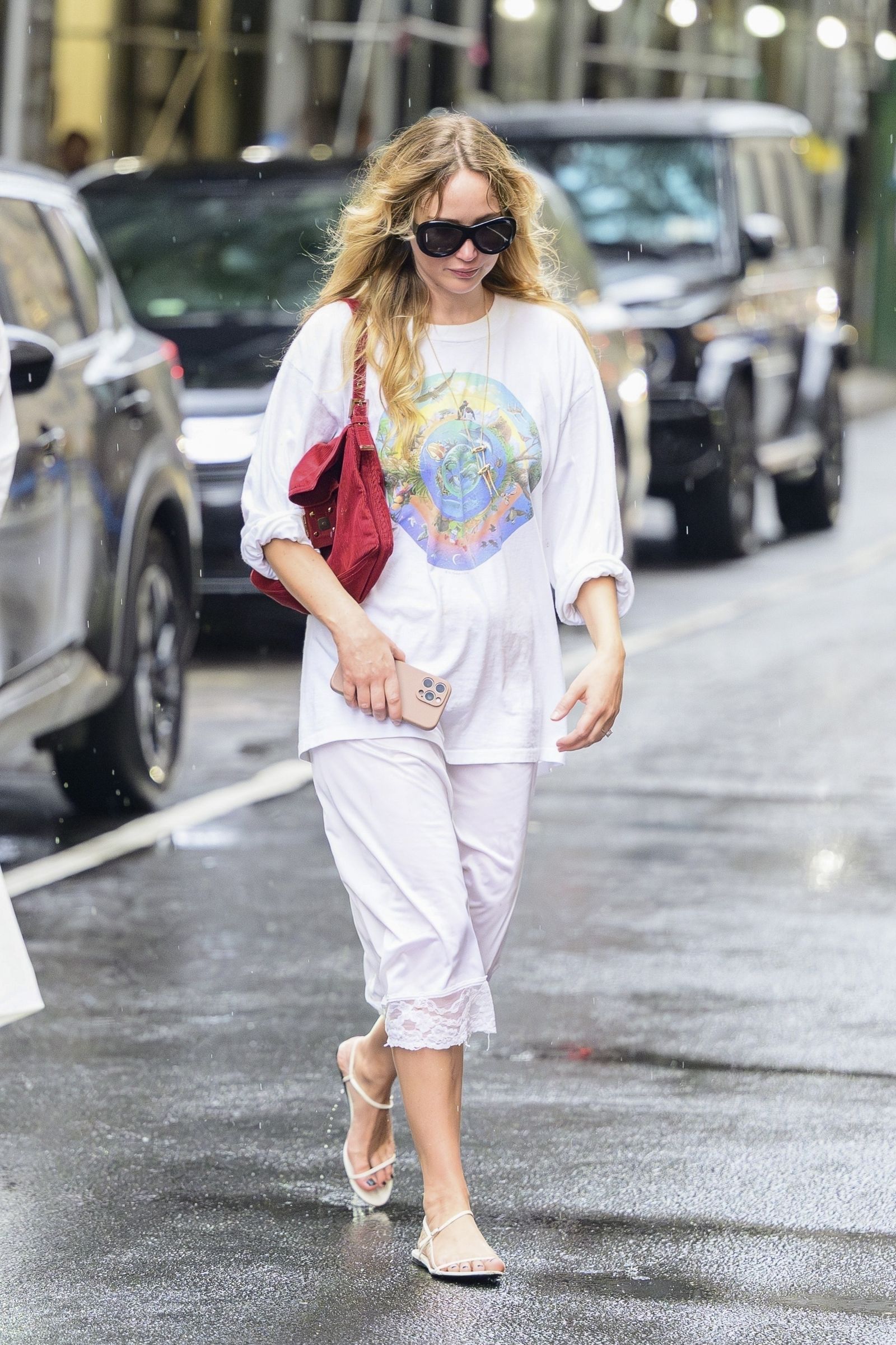 Image may contain Jennifer Lawrence Clothing Pants Pedestrian Person Adult Accessories Bag Handbag and Footwear