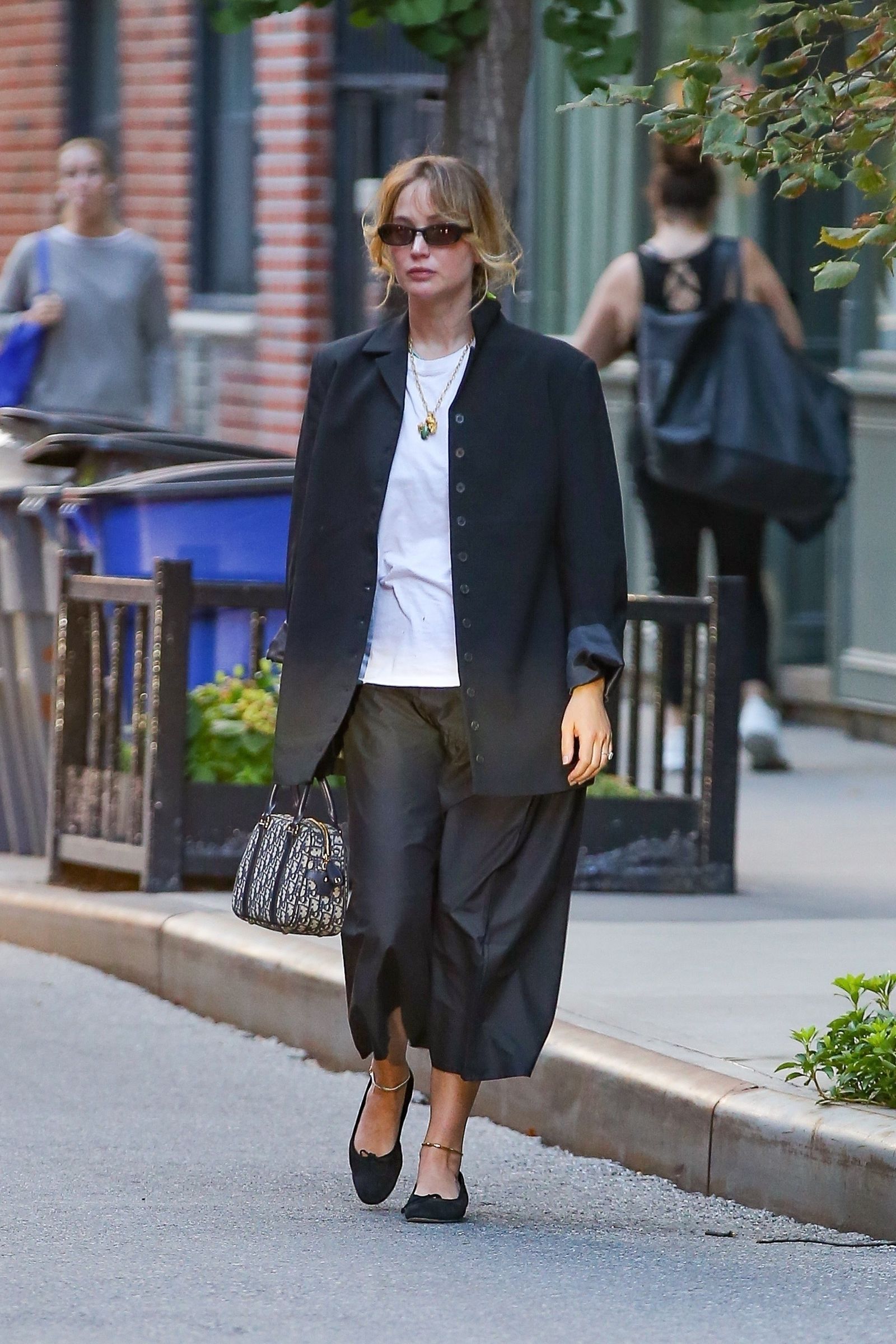 EXCLUSIVE New York NY Actress and busy mom Jennifer Lawrence looks stunning in black and white ensemble while sporting a...