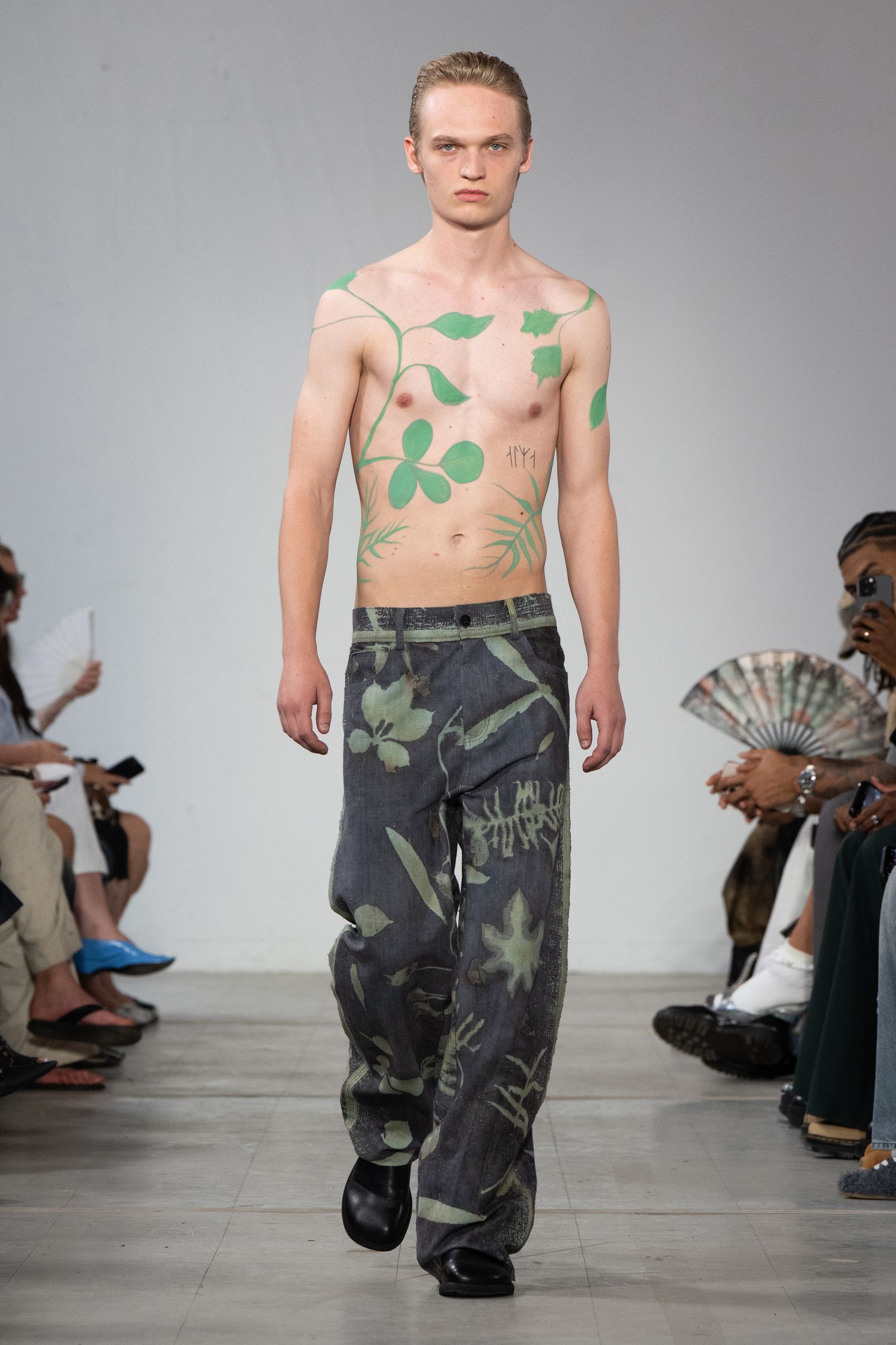 Image may contain Lucretius Clothing Pants Fashion Adult Person Footwear Shoe Electronics Mobile Phone and Phone