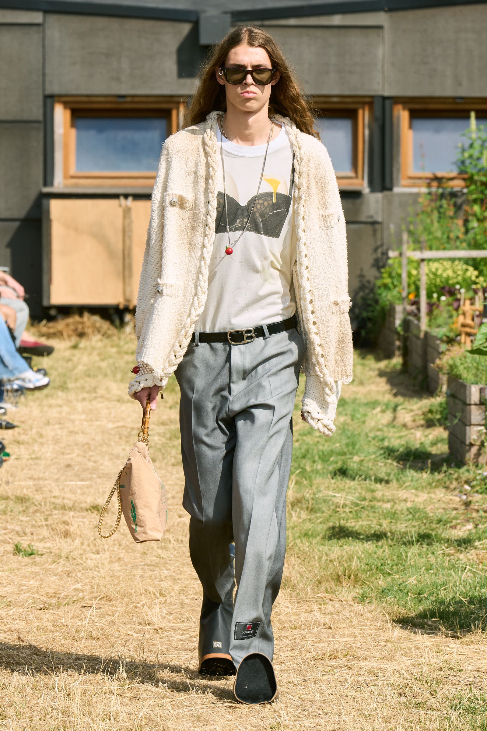 Image may contain Clothing Pants Accessories Belt Jewelry Necklace Adult Person Blazer Coat Jacket and Footwear