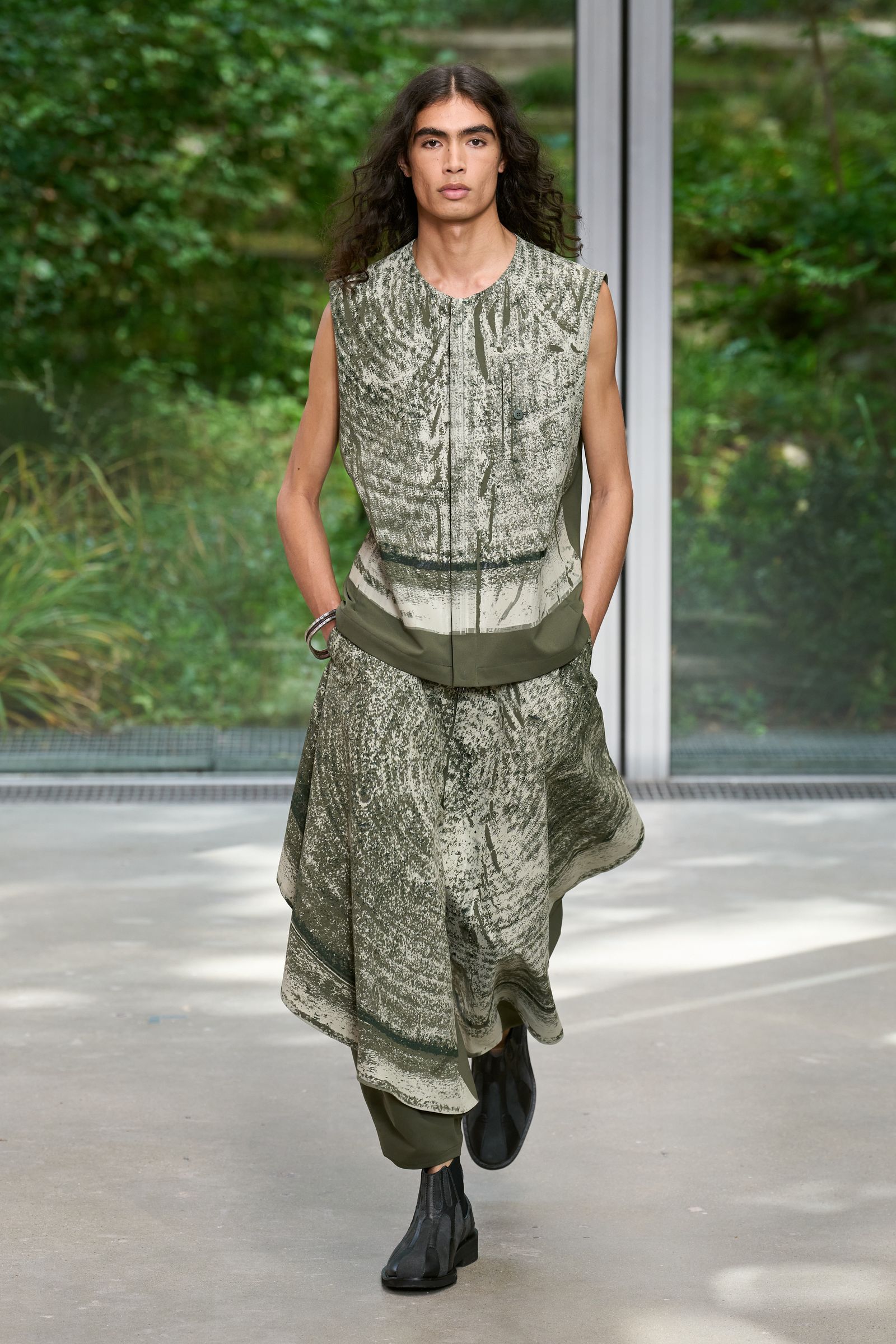 Image may contain Adult Person Clothing Dress Vest Fashion Footwear and Shoe