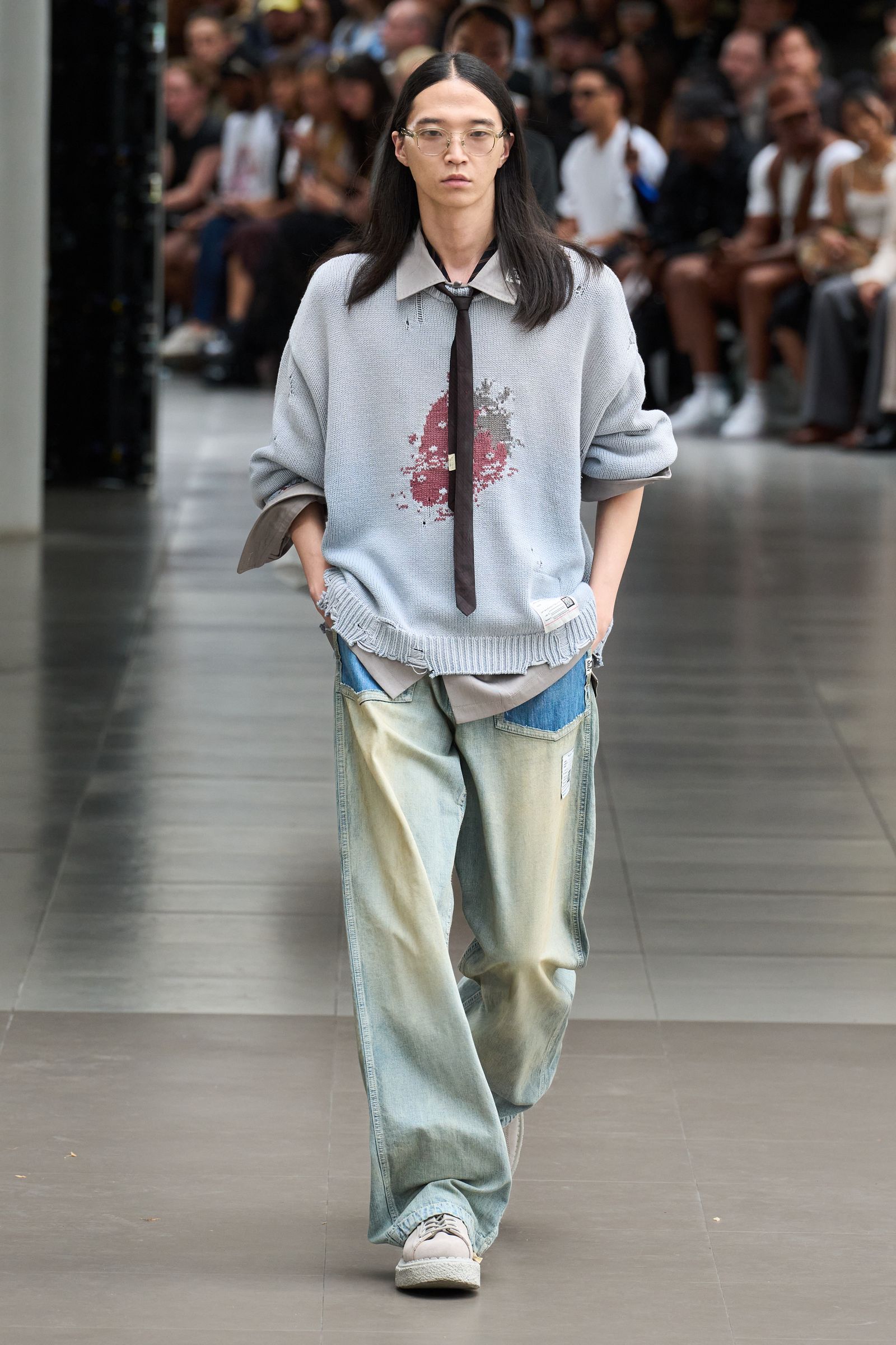 Image may contain Clothing Pants Accessories Glasses Person Formal Wear Tie Footwear Shoe Fashion Adult and Jeans