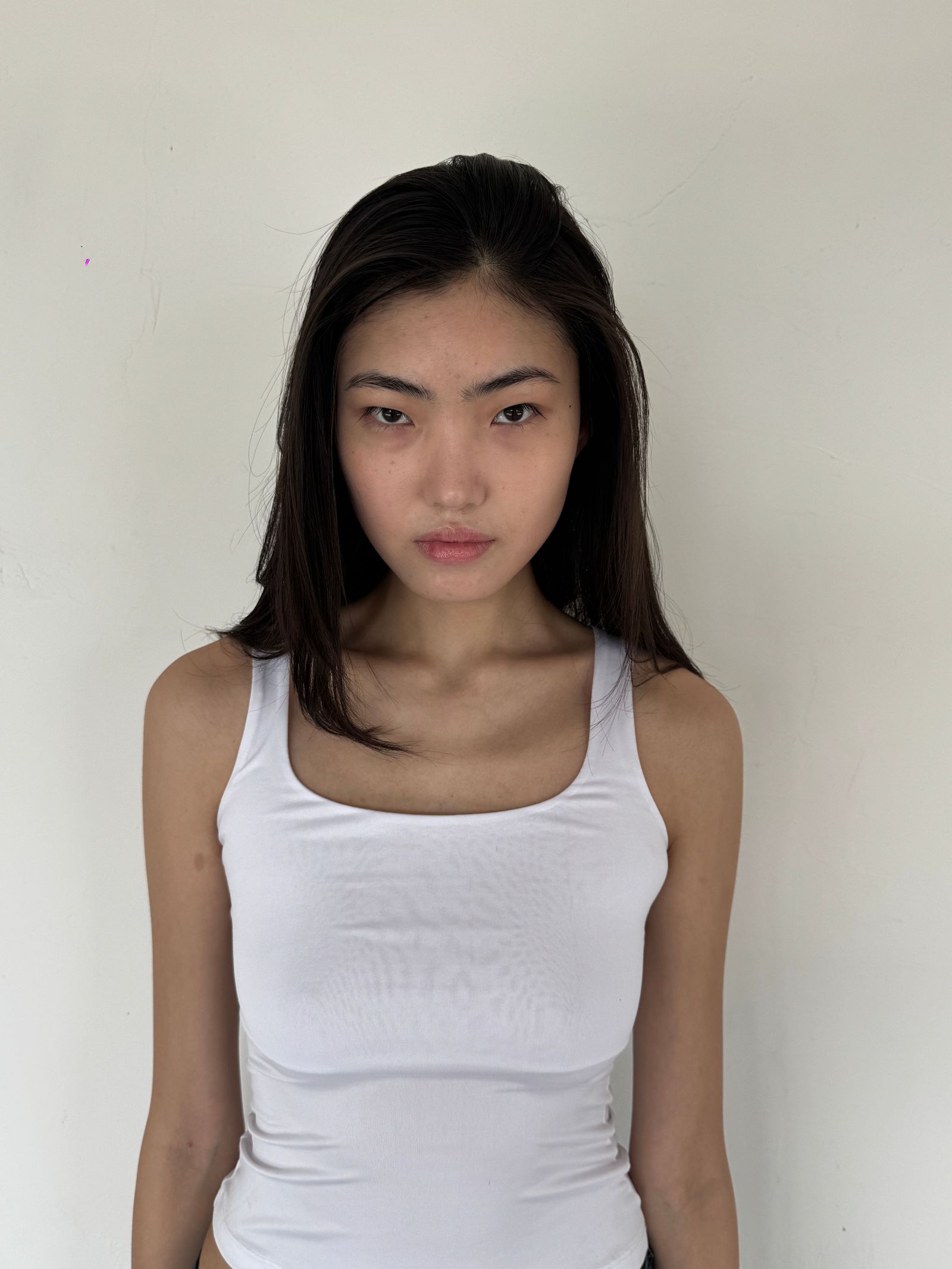 Image may contain Head Person Face Photography Portrait Body Part Neck Adult Clothing and Tank Top