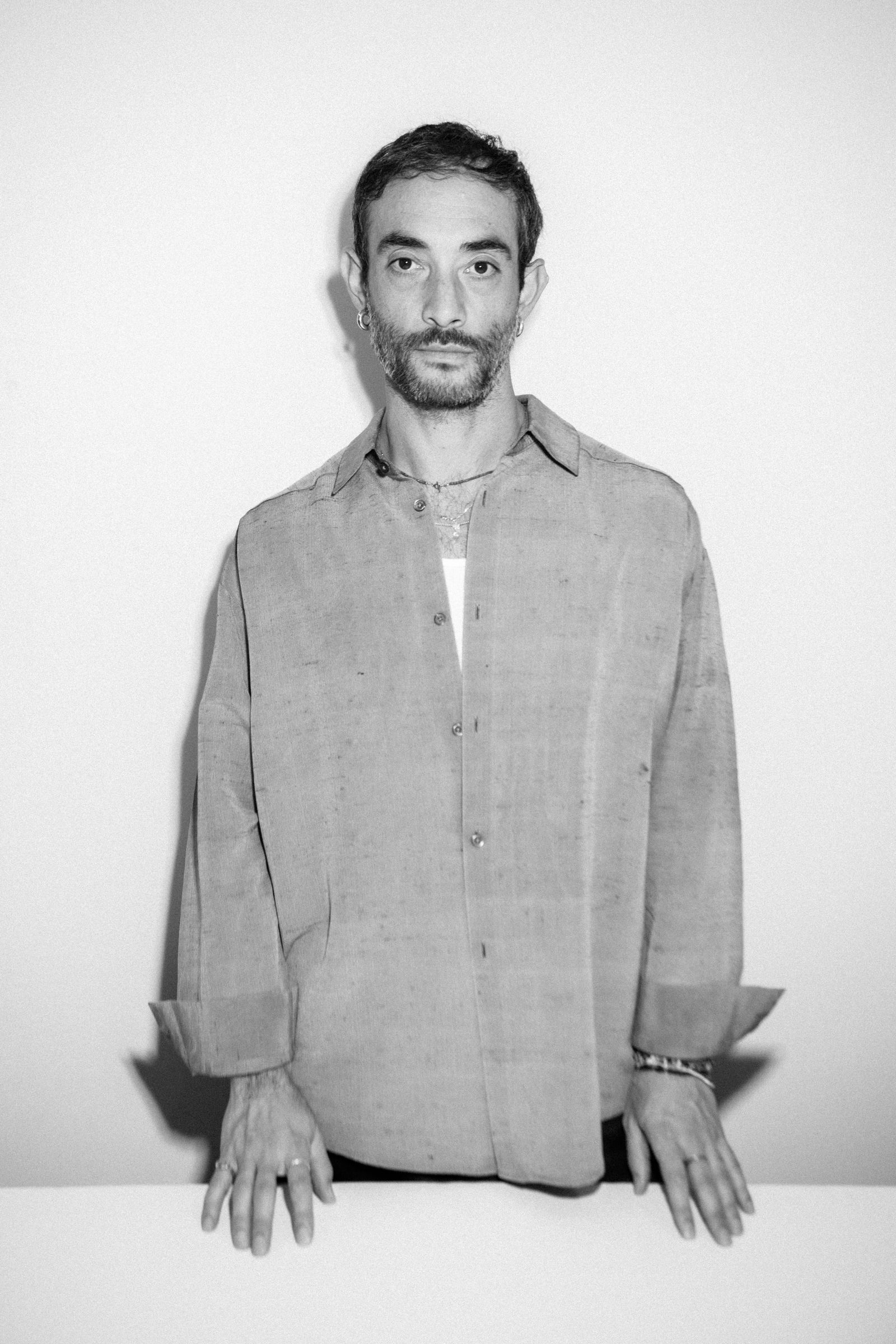 Image may contain Face Head Person Photography Portrait Happy Smile Adult Clothing Shirt Body Part and Finger