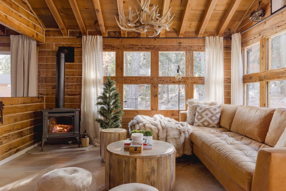 Image may contain Wood Indoors Interior Design Coffee Table Furniture Table Chandelier Lamp Plant and Tree